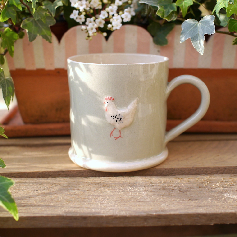 Lovely Jane Hogben Pottery Mug in Pale Green featuring the Chicken design.
