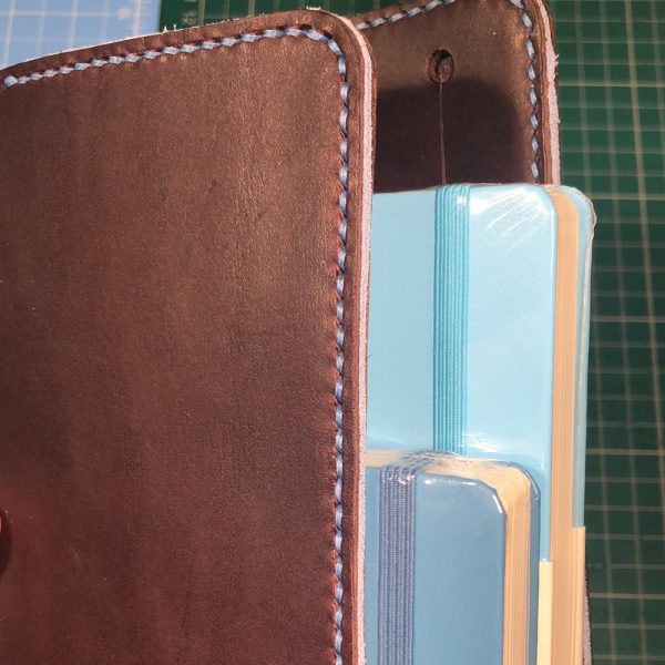 Journal & Hide A5 Journal Cover: Chocolate leather, Powder Blue Stitching. Powder Blue Suede Sandwich. Top notebook: Ice Blue, bottom notebook: Nordic Blue.